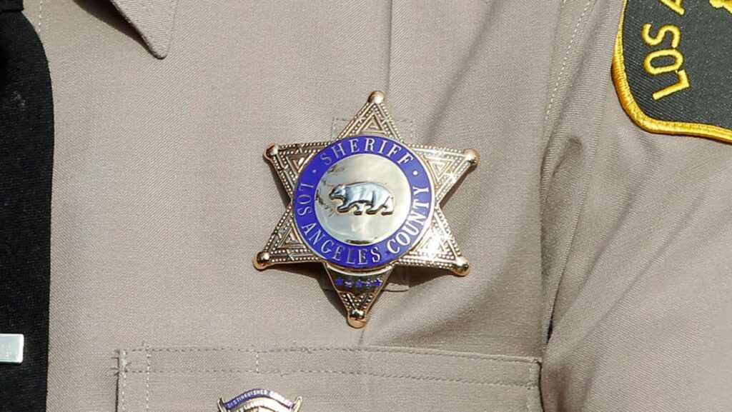 Los Angeles County Sheriff badge and uniform close up.