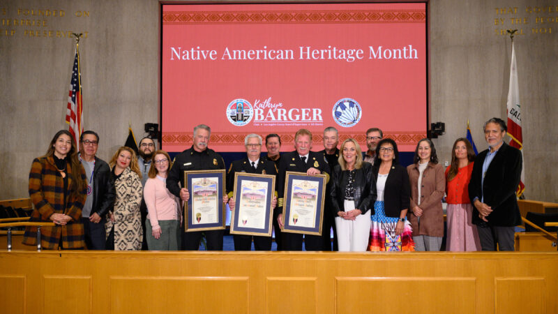 Supervisor Barger stands in the Board room alongside honorees and commissioners.