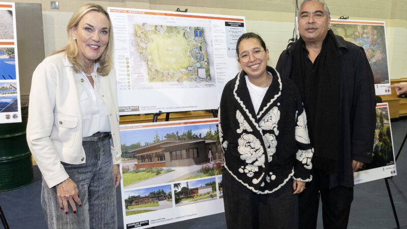 Supervisor Kathryn Barger poses in front of rendering of the future Charles White Park Community Center and park plan, alongside Paulina Alvarez and Ian White, son of the park's namesake, Charles White.
