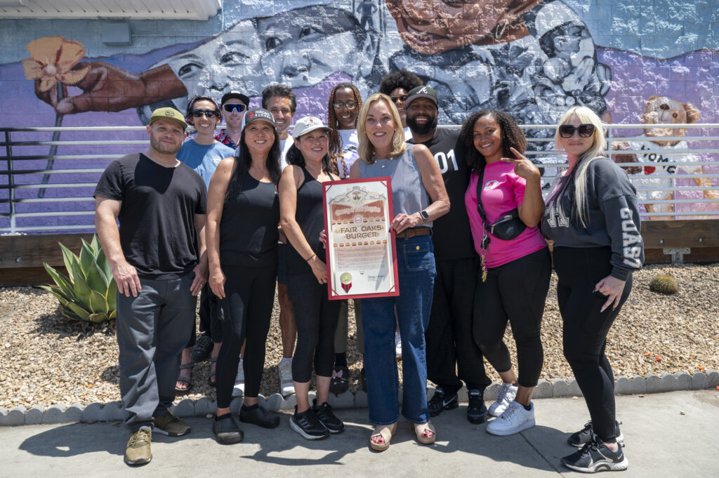 Supervisor Kathryn Barger stands with Fair Oaks Burger owner Christy Lee and community members in front of Robert Vargas’ mural From the Ashes.