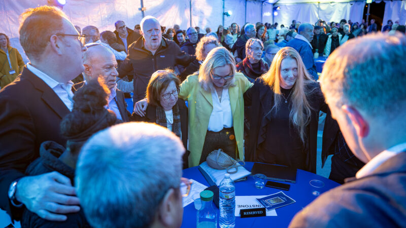 Supervisor Barger and attendees stand and recite a prayer together.
