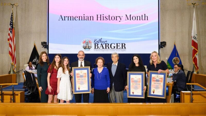 Supervisor Kathryn Barger presents commemorative scrolls to Armenian community honorees during a ceremony at the Los Angeles County Board of Supervisors. Pictured from left: Jill Panossian, Leah and Samantha Panossian, Dr. Andre Panossian and his parents, ServiceTitan representative Alene Aroustamian, and Supervisor Barger.